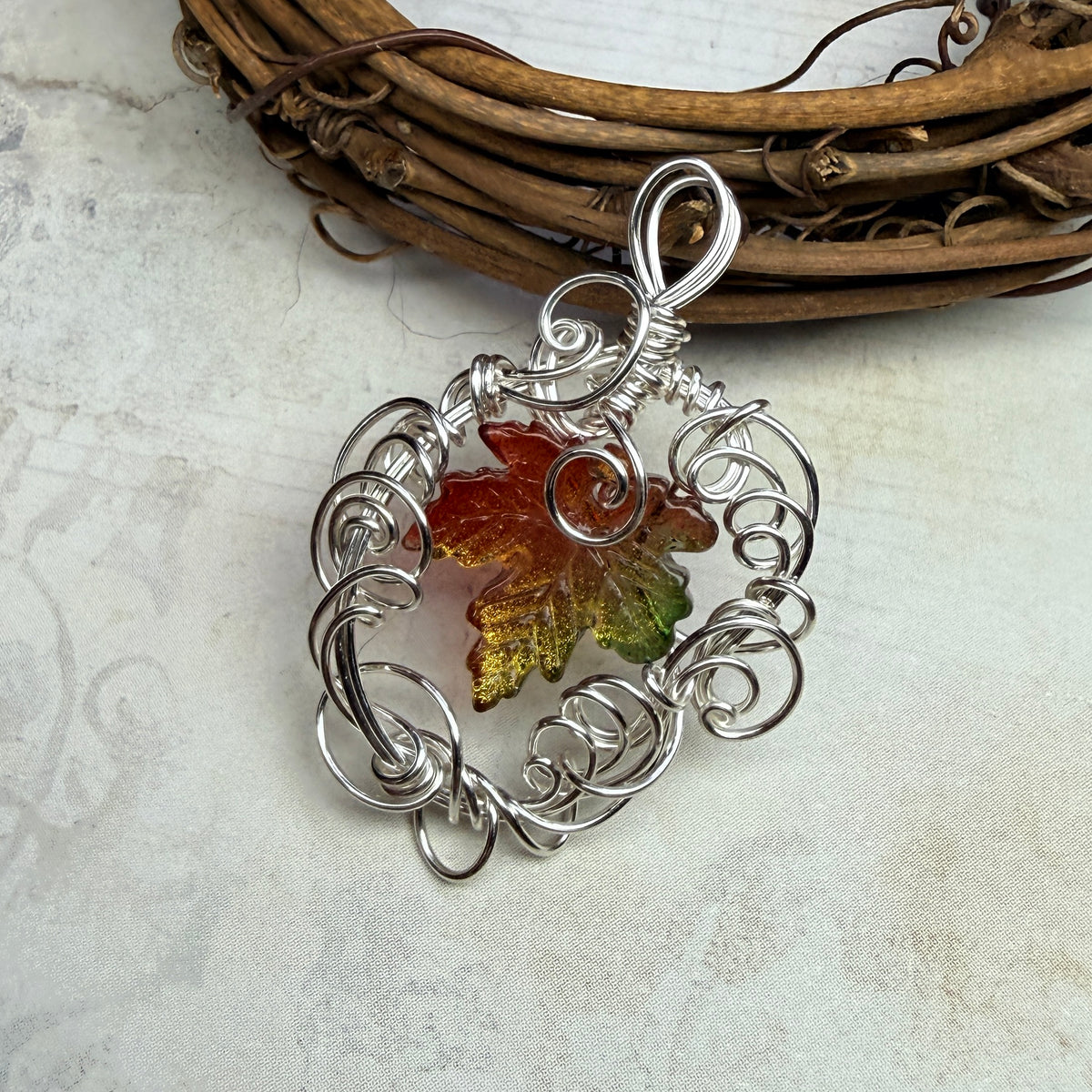 on autumn winds: green and orange leaf pendant
