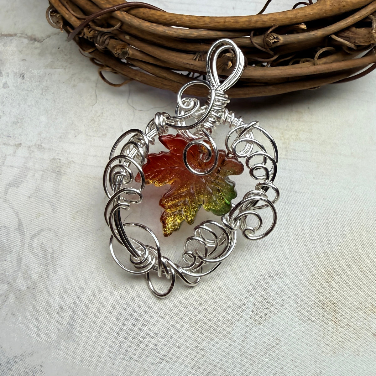 on autumn winds: green and orange leaf pendant