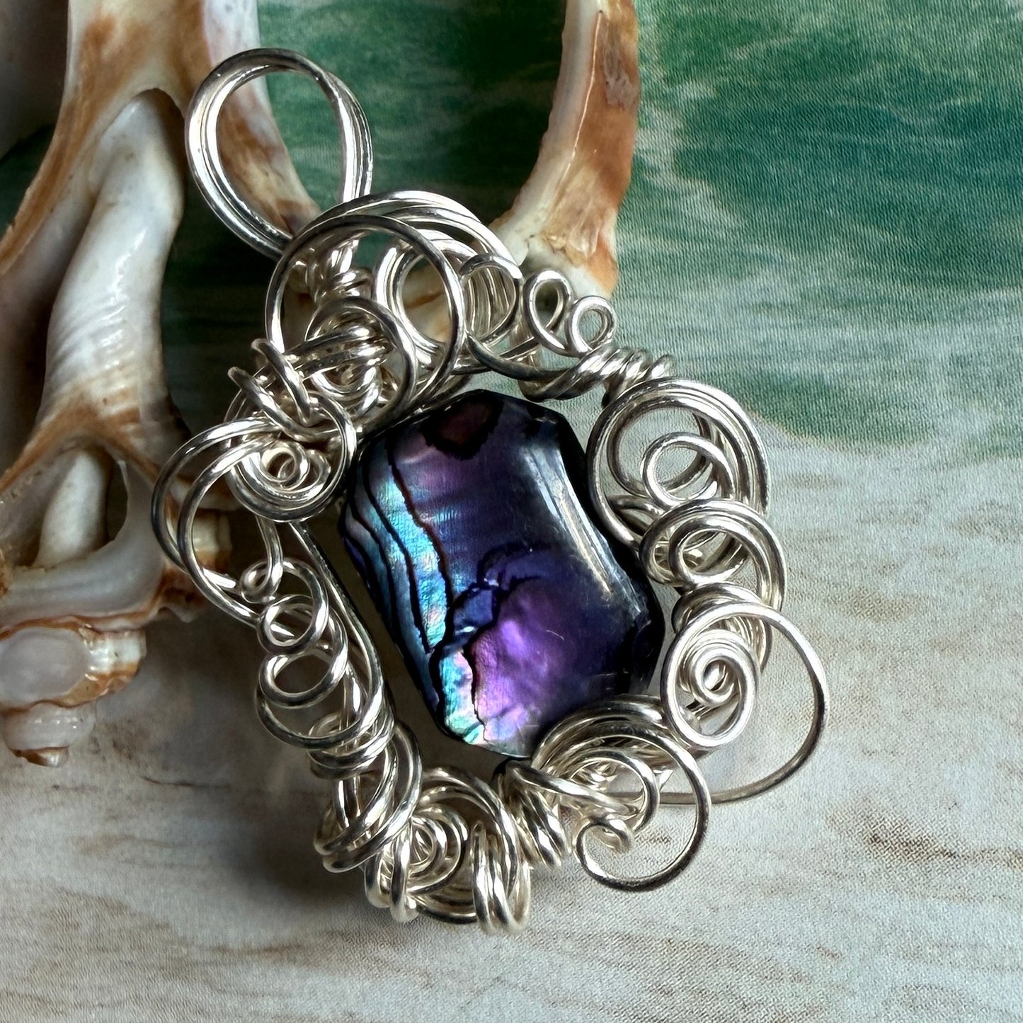 on the turning tide - purple paua shell pendant