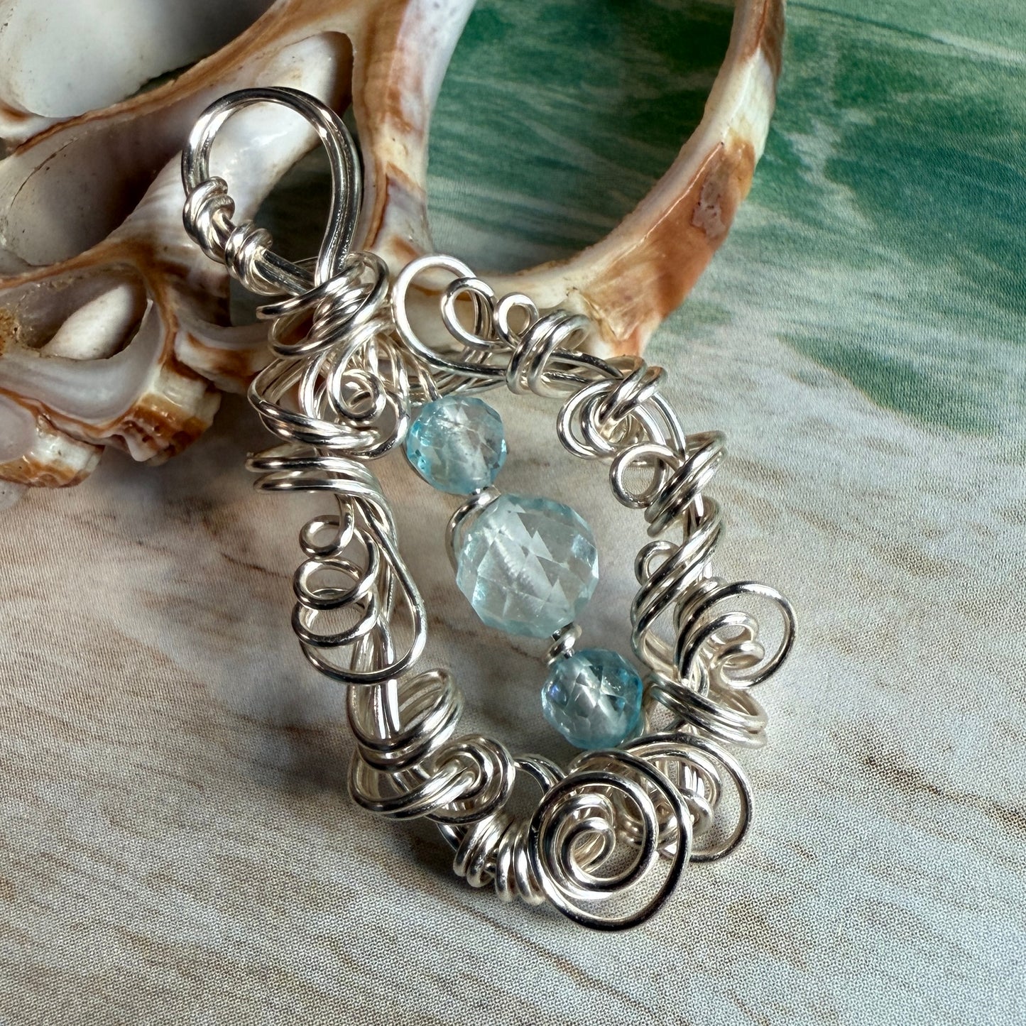on the turning tide - blue topaz pendant