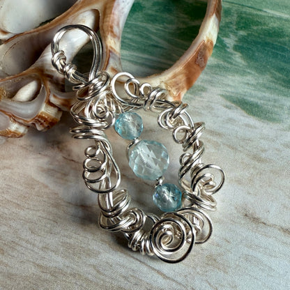 on the turning tide - blue topaz pendant
