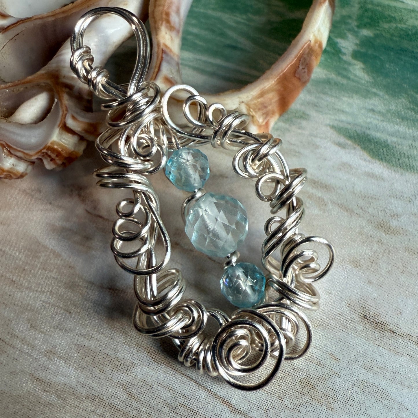 on the turning tide - blue topaz pendant
