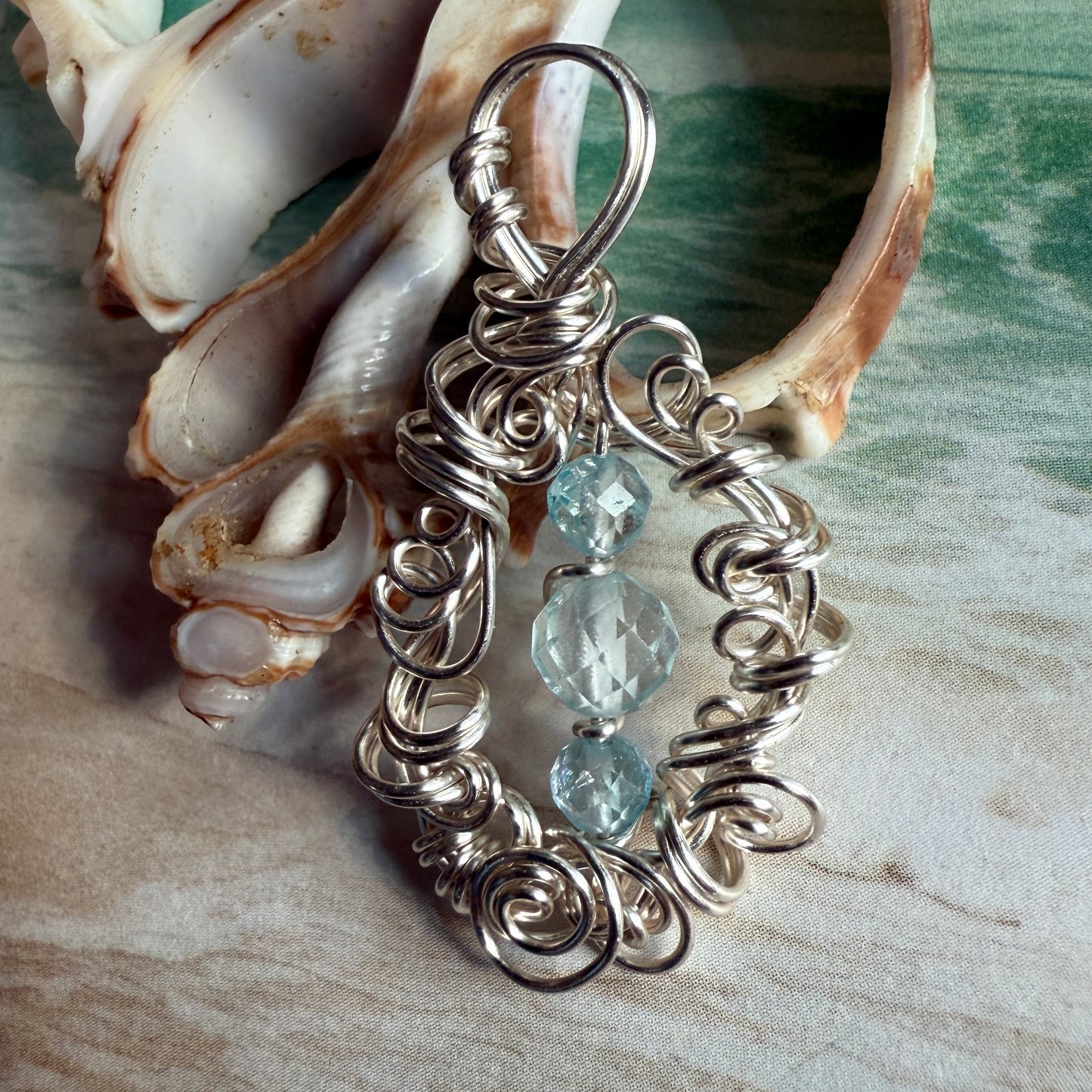 on the turning tide - blue topaz pendant