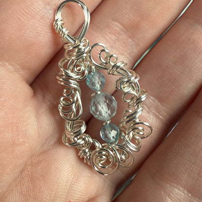 on the turning tide - blue topaz pendant