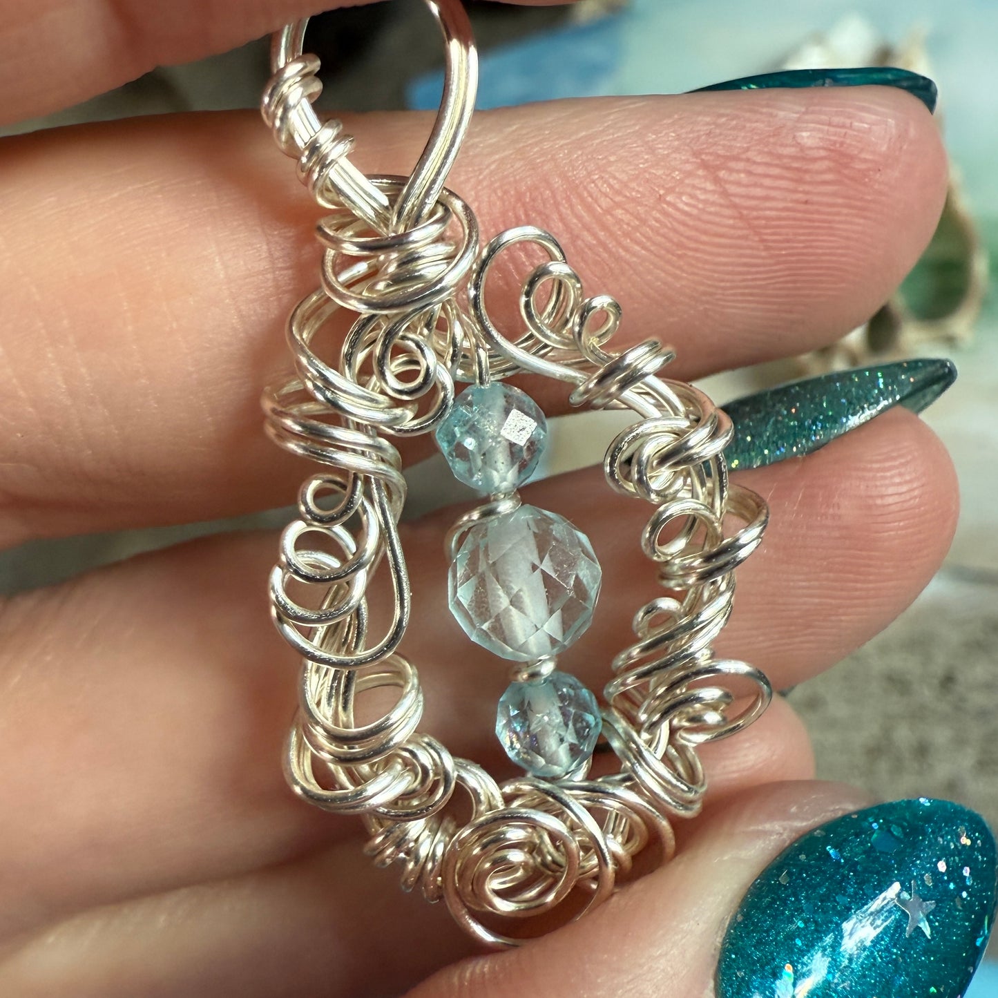 on the turning tide - blue topaz pendant