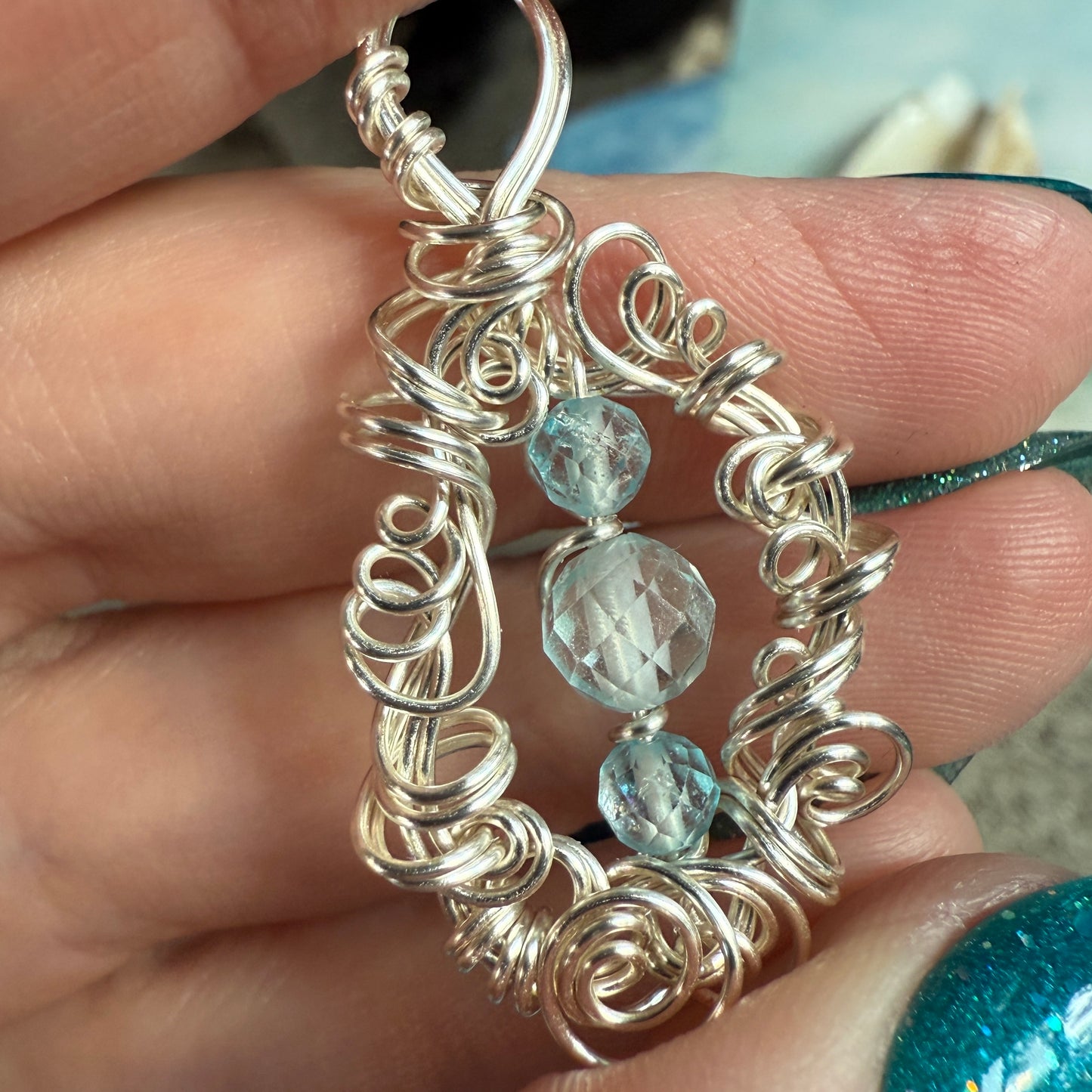 on the turning tide - blue topaz pendant